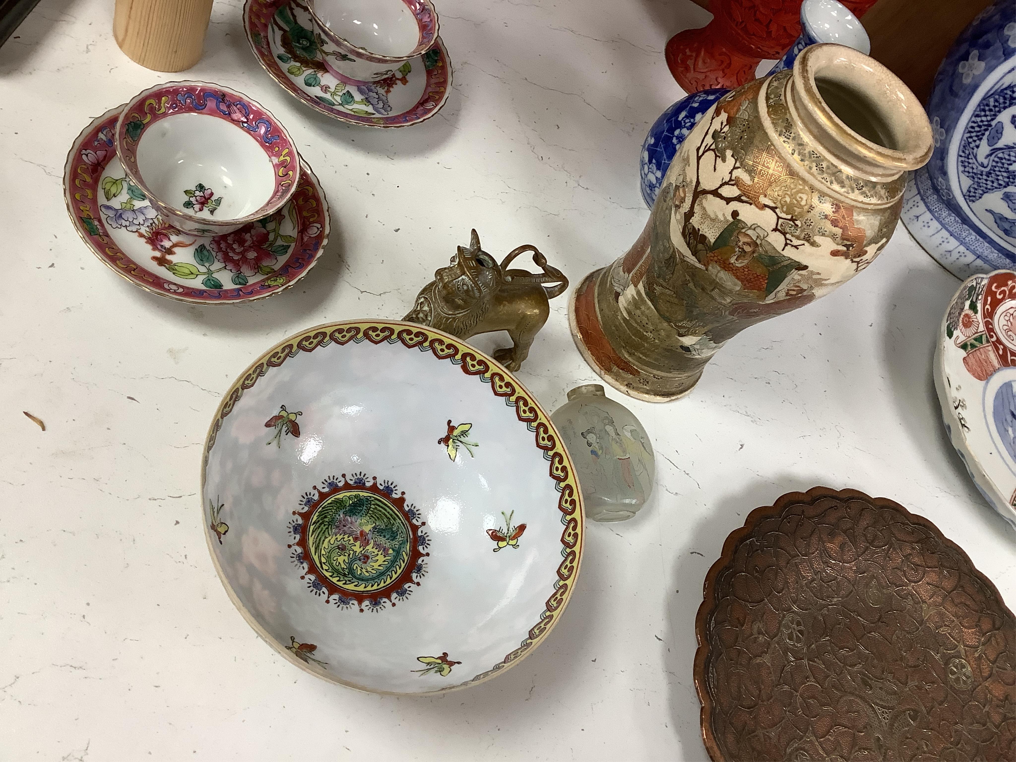 A group of mixed oriental porcelain and metalware to include a Japanese satsuma vase, cinnabar lacquer vase and blue and white teapot, largest 32cm high.